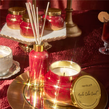 Apple Cider Social red and gold glimmer reed diffuser and scented candle.