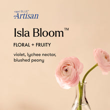 Advertisement for capri BLUE Artisan Isla Bloom with pink flowers in a vase on a beige background.