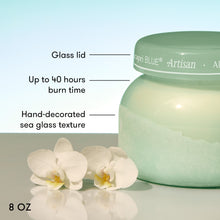 Capri Blue Artisan candle with features highlighted on a light background