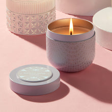 A Capri Blue Gilded Muse Tin with a flickering flame