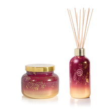 Tinsel & Spice Reed Diffuser and Signature Candle on a white background.