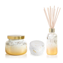 Volcano Glimmer Signature Candle, Mini Tin Candle and Reed Diffuser on a white background