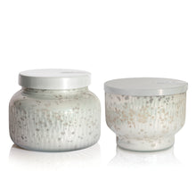 Two Volcano Holiday Mercury candles on a white background