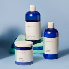 Three bottles of Capri Blue Volcano body wash on a blue background