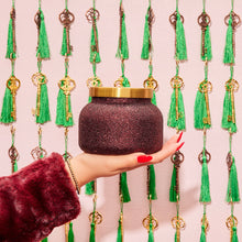 Tinsel & Spice Glam Signature Candle in hand