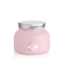 Pink candle jar with silver lid on a white background