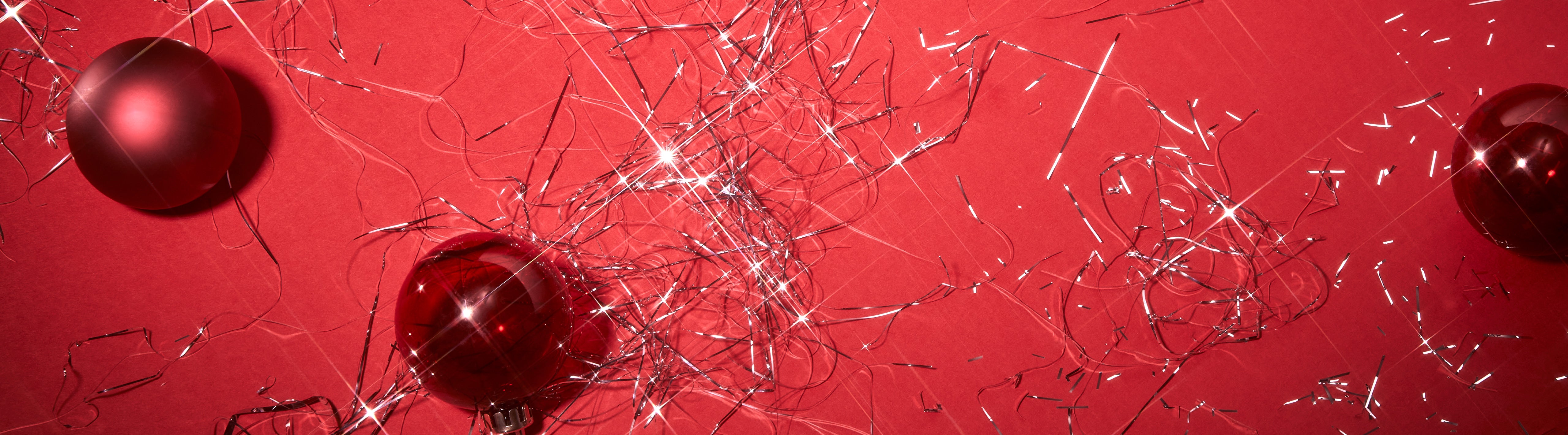 Ornaments and tinsel on a red background