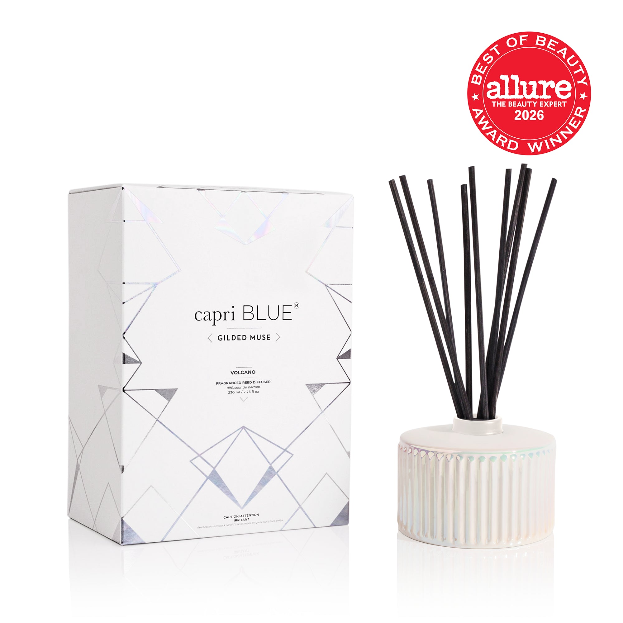 A white opal gilded reed diffuser with black reeds next to its white, geometric patterned packaging box and the Allure 2026 Best of Beauty Award Winner seal. 