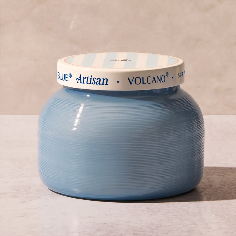 A light blue ribbed ceramic jar with a white lid featuring light blue stripes and blue text that reads 'BLUE Artisan VOLCANO'.
