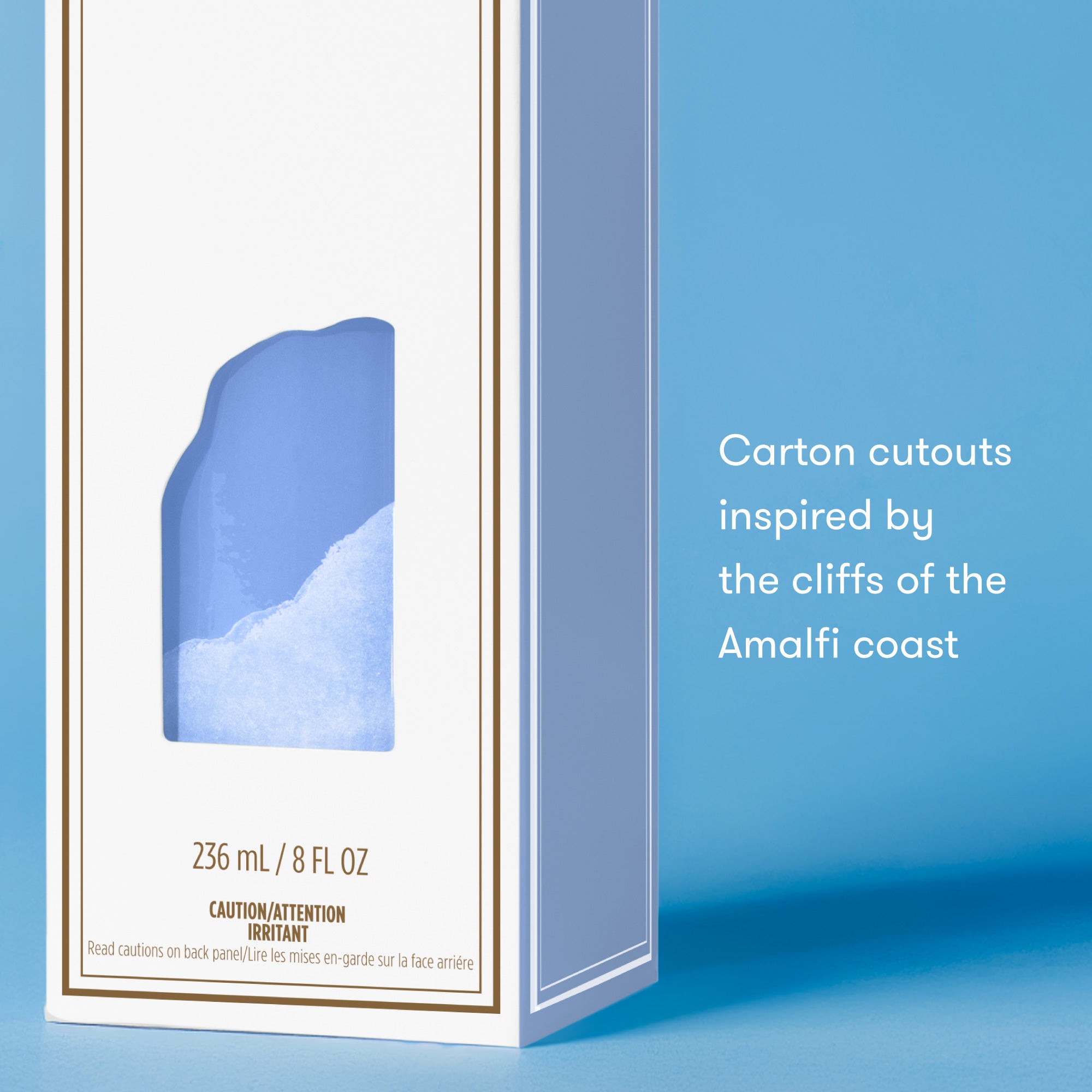 Product packaging with blue cliff design inspired by the Amalfi coast on a blue background