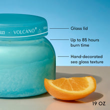 Blue jar labeled 'Volcano' with an orange slice on a blue background