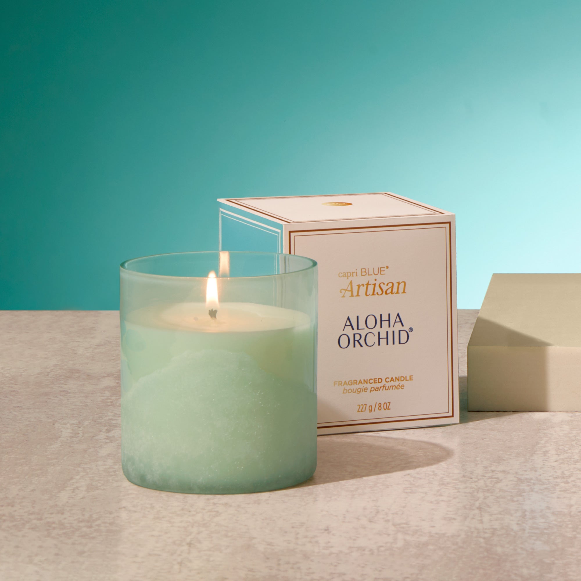 Aloe Orchid candle with packaging on a neutral background