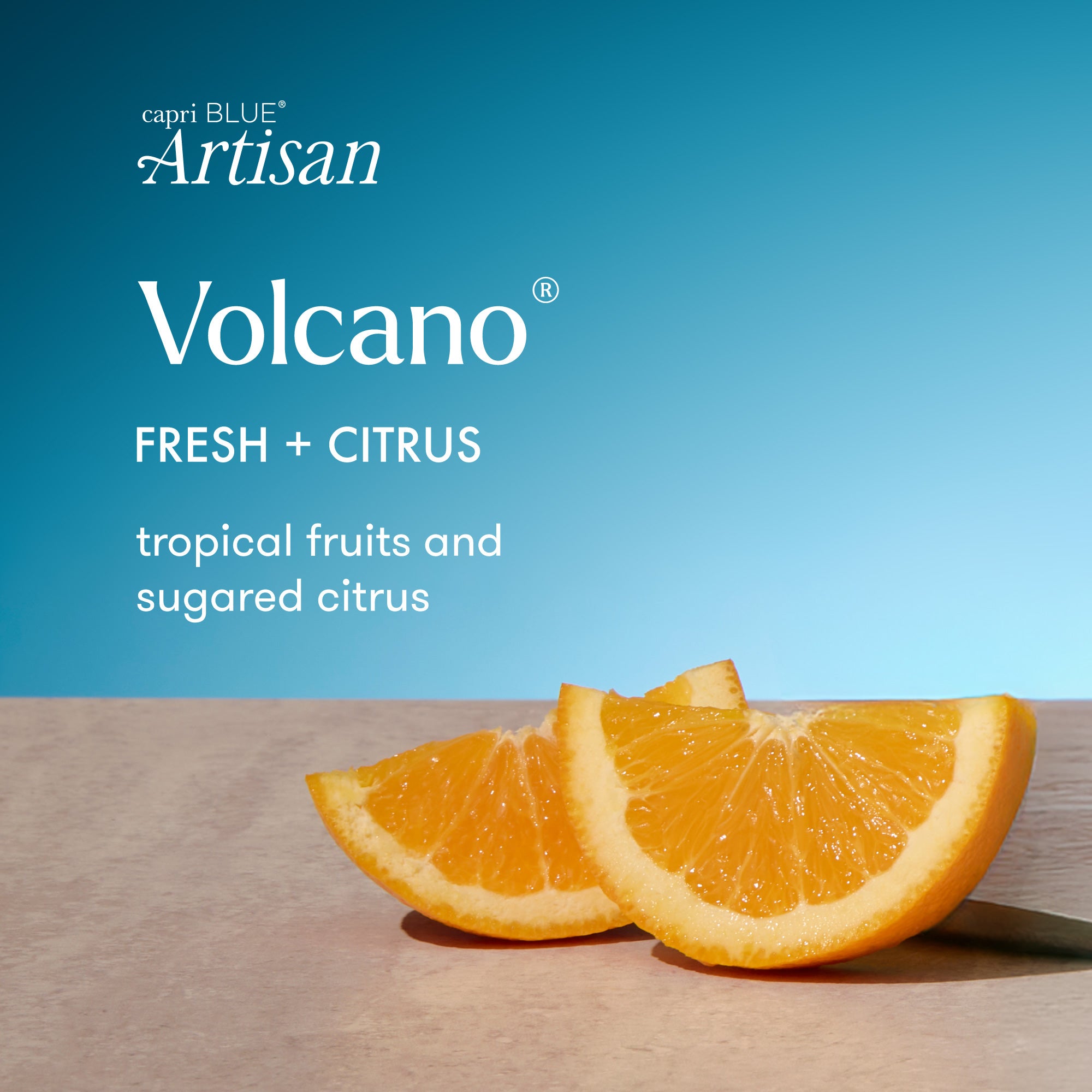 Two orange slices on a wooden surface with a blue background and 'capri BLUE Artisan Volcano' branding.