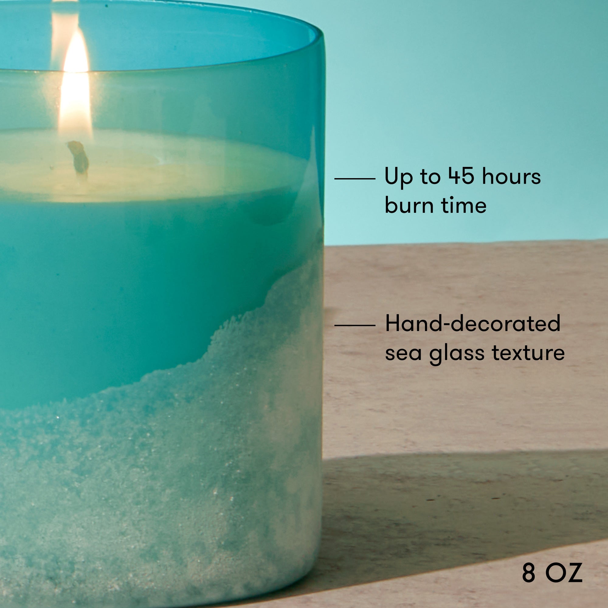 Teal candle with sand texture and text indicating burn time and size.