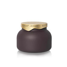 A dark brown jar of hair product with a light wood lid and a gold paper band around the neck, featuring the brand name 'BLUE ARTISAN'.