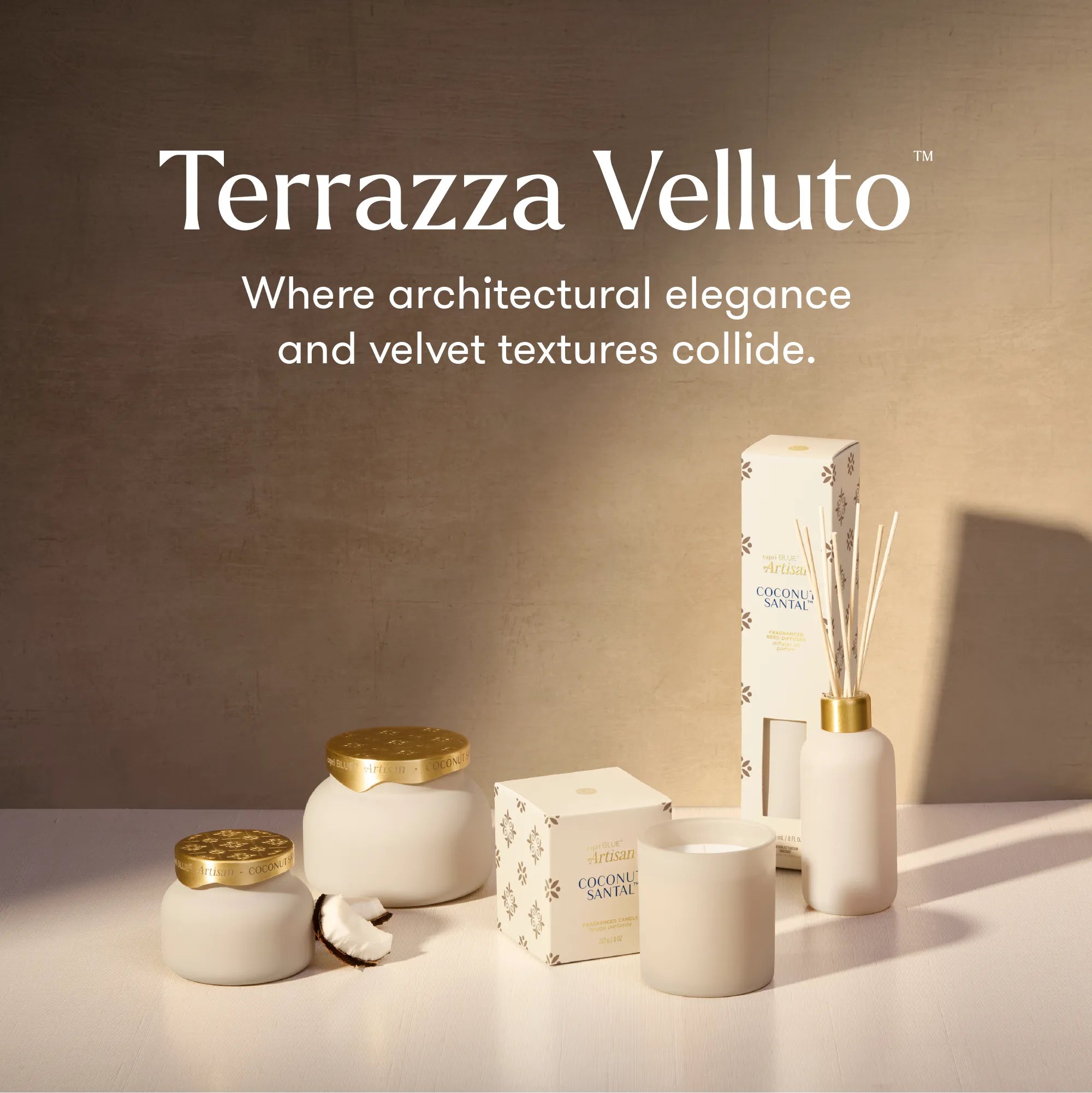 Terrazza Velluto home fragrance set including a reed diffuser, candle, jar, and box, styled on a white surface against a textured beige wall with warm lighting.