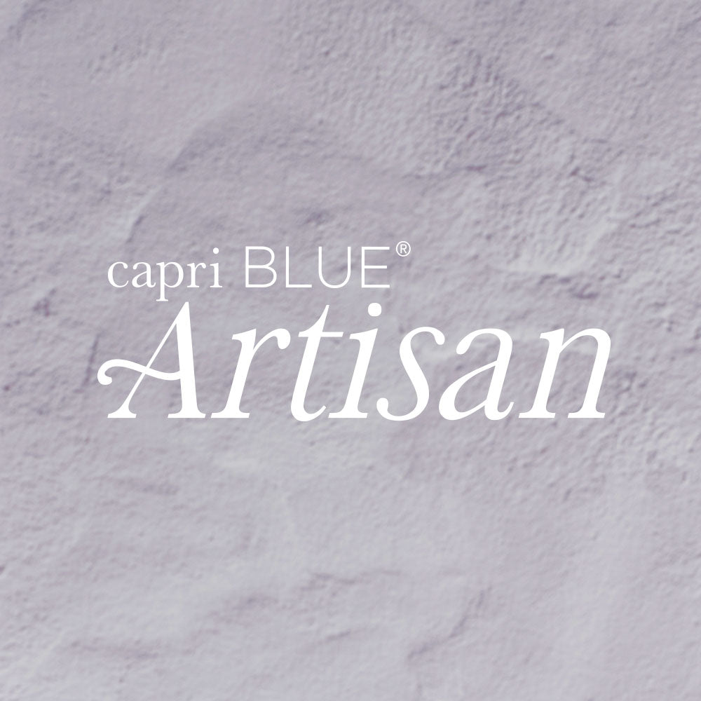 Text 'capri BLUE Artisan' on a textured gray background
