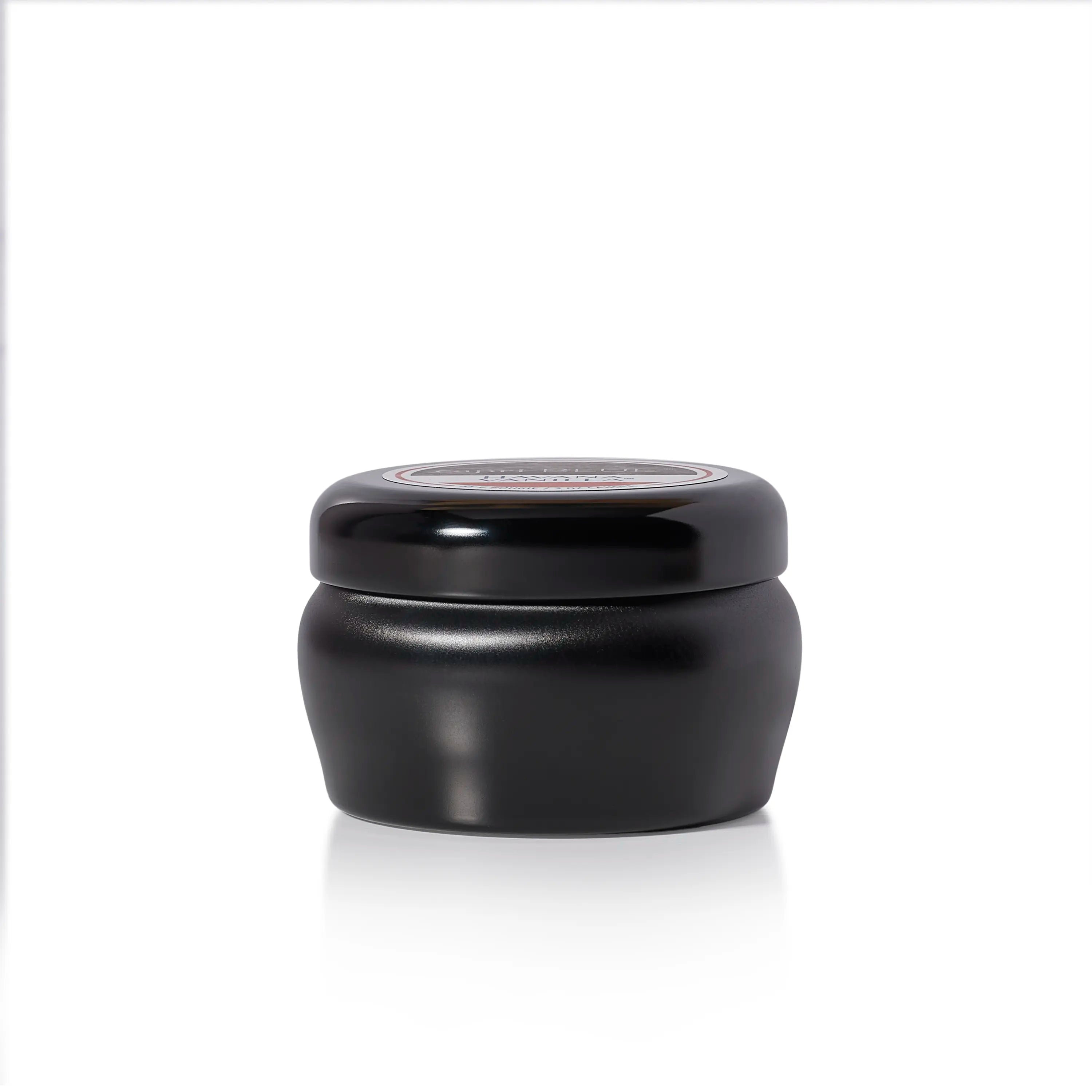 A small black candle jar with a matching black screw-top lid, photographed on a clean white background with a soft reflection underneath.