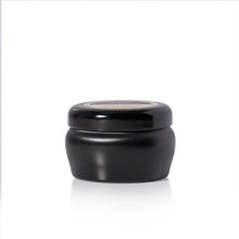 A small black candle jar with a matching black screw-top lid, shown on a clean white background with a soft reflection underneath.