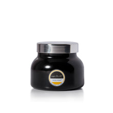 A black jar candle with a shiny silver lid and a circular label reading 'Capri BLUE VOLCANO' on a clean white background.