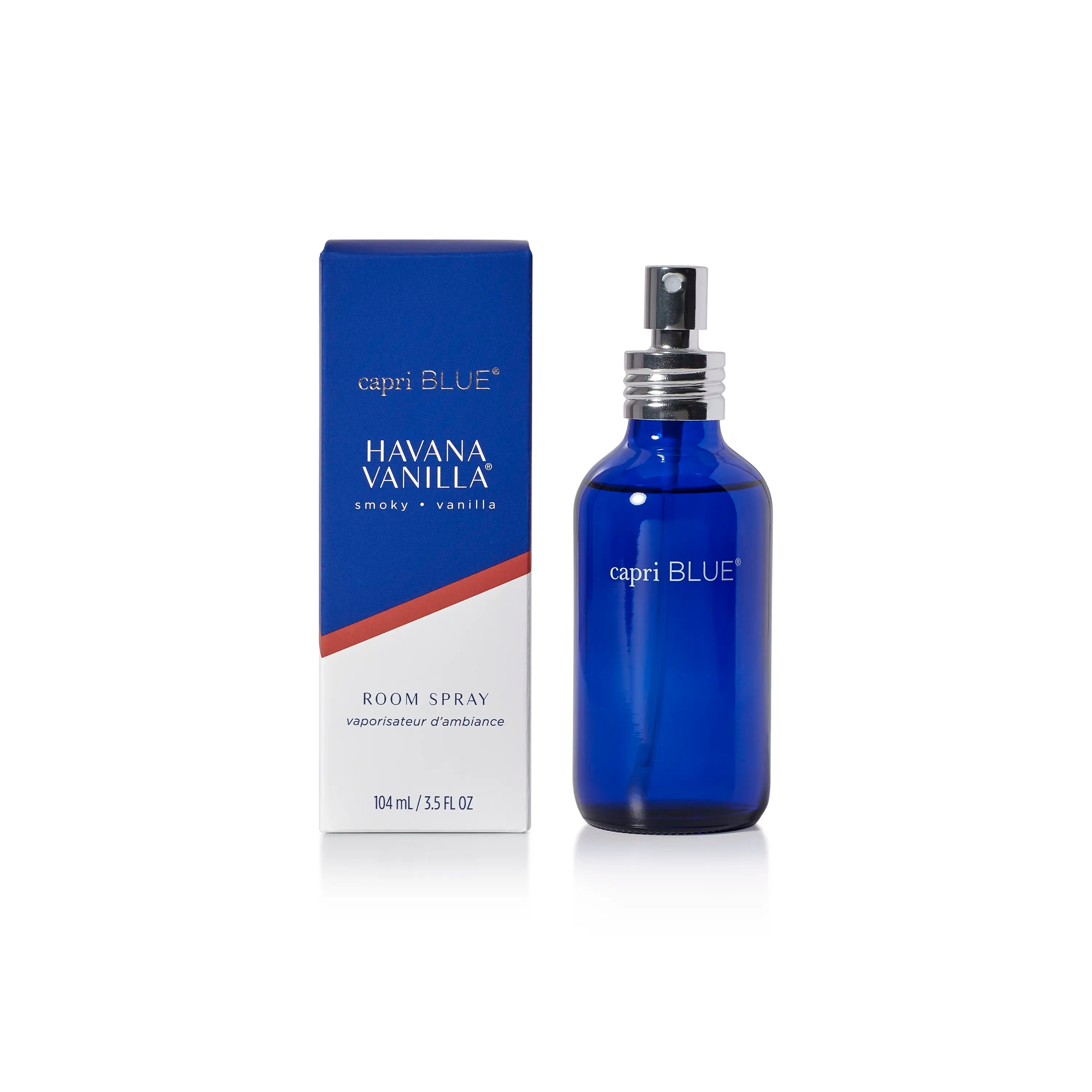 A cobalt blue glass bottle of capri BLUE Havana Vanilla room spray next to its blue and white packaging box on a white background.