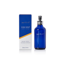 A cobalt blue glass bottle of capri BLUE Volcano Fresh + Citrus room spray stands next to its blue and white packaging box with a gold accent stripe, on a clean white background.