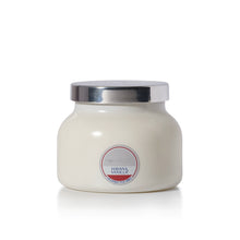 A capri BLUE Candle in a white ceramic jar with a shiny silver metal lid, labeled 'Havana Vanilla' on the front, set against a plain white background.