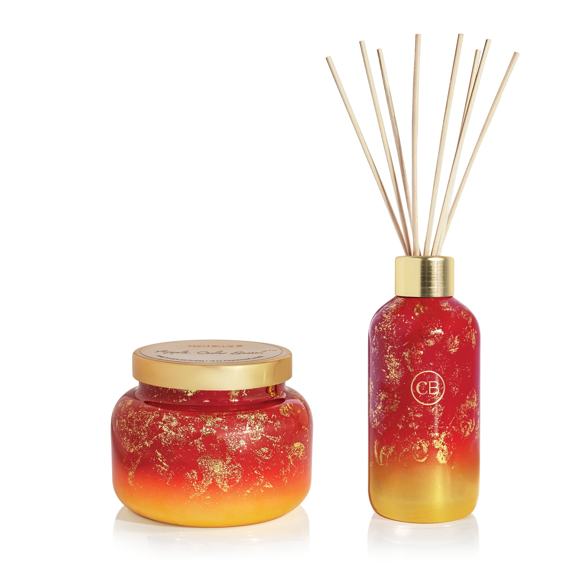 Red and gold scented candle and diffuser set on a white background