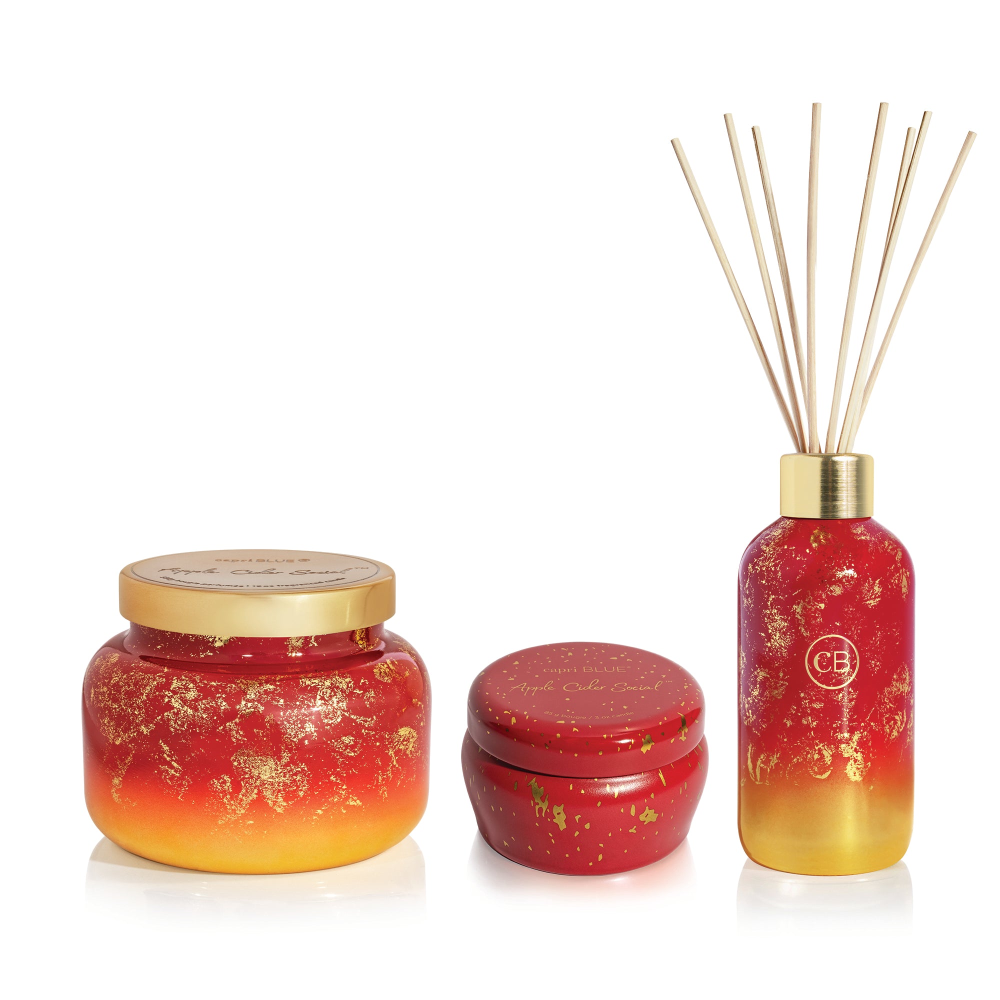 Set of red and gold scented products including a jar, small container, and diffuser on a white background.