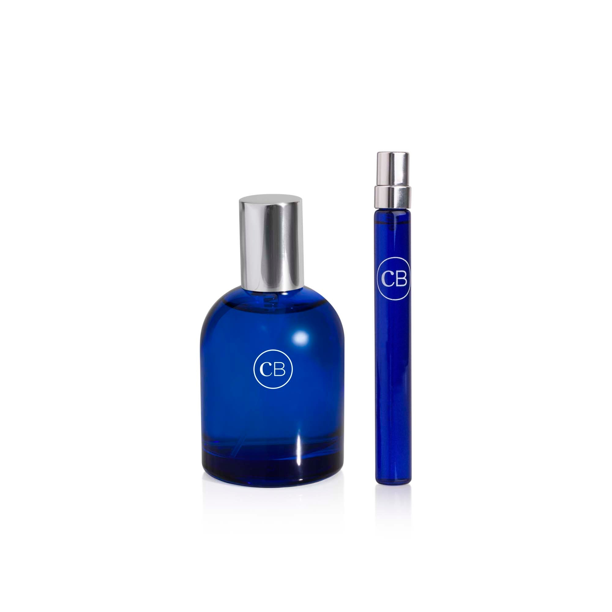 Two blue perfume bottles with silver caps on a white background