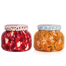 Two decorative scented candle jars with floral patterns on a white background