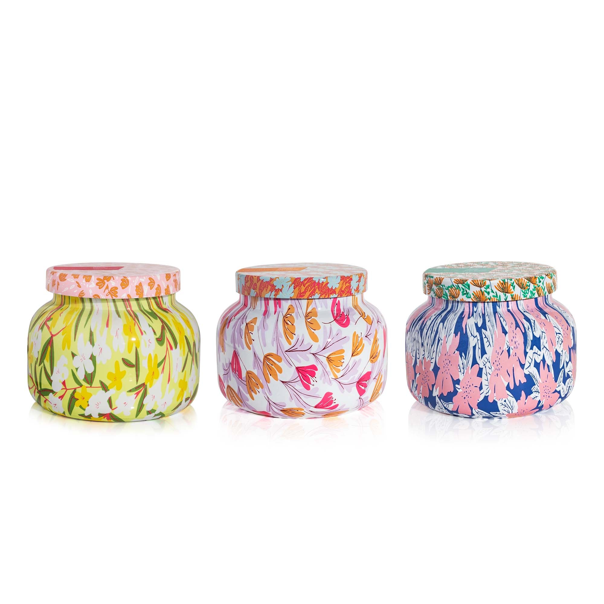 Three colorful patterned jars with lids on a white background