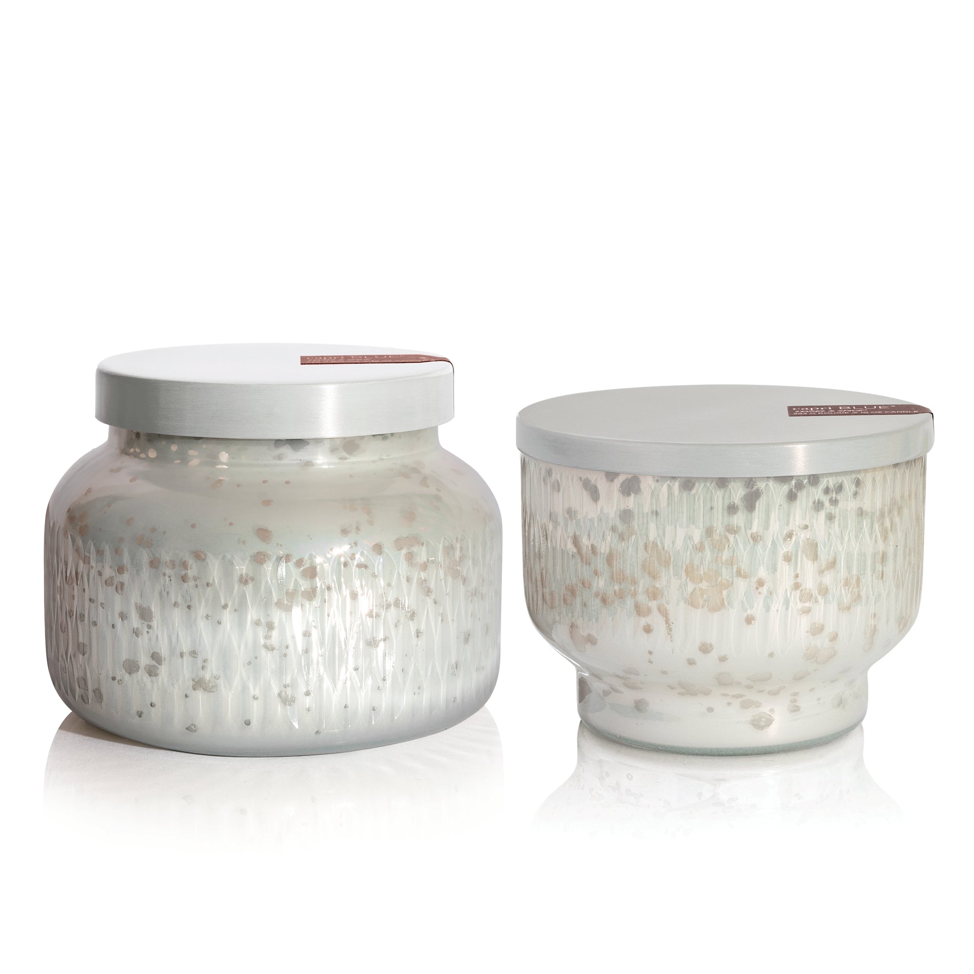 Two Tinsel & Spice Holiday Mercury Candles on a white background