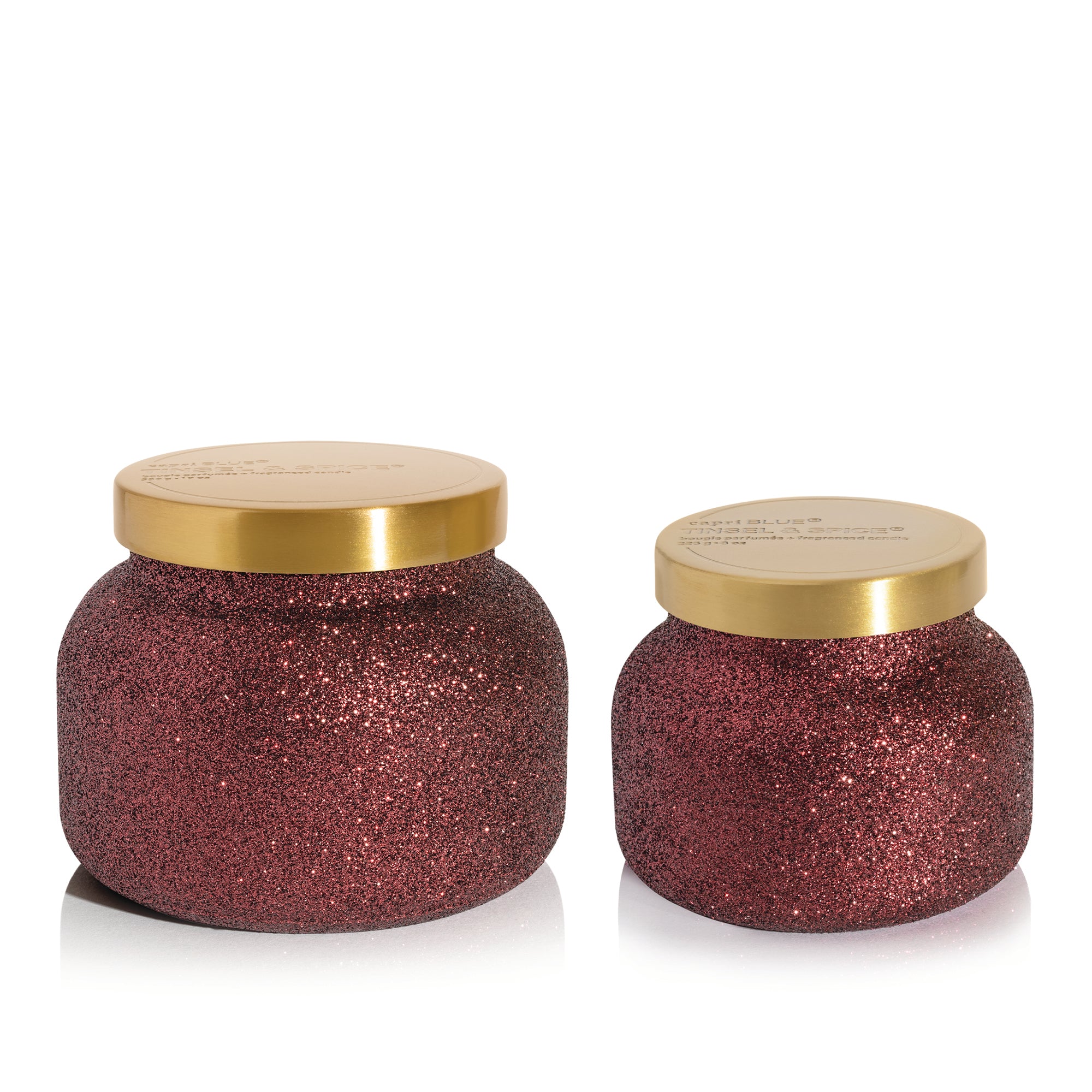 Two Tinsel & Spice Candles on a white background.