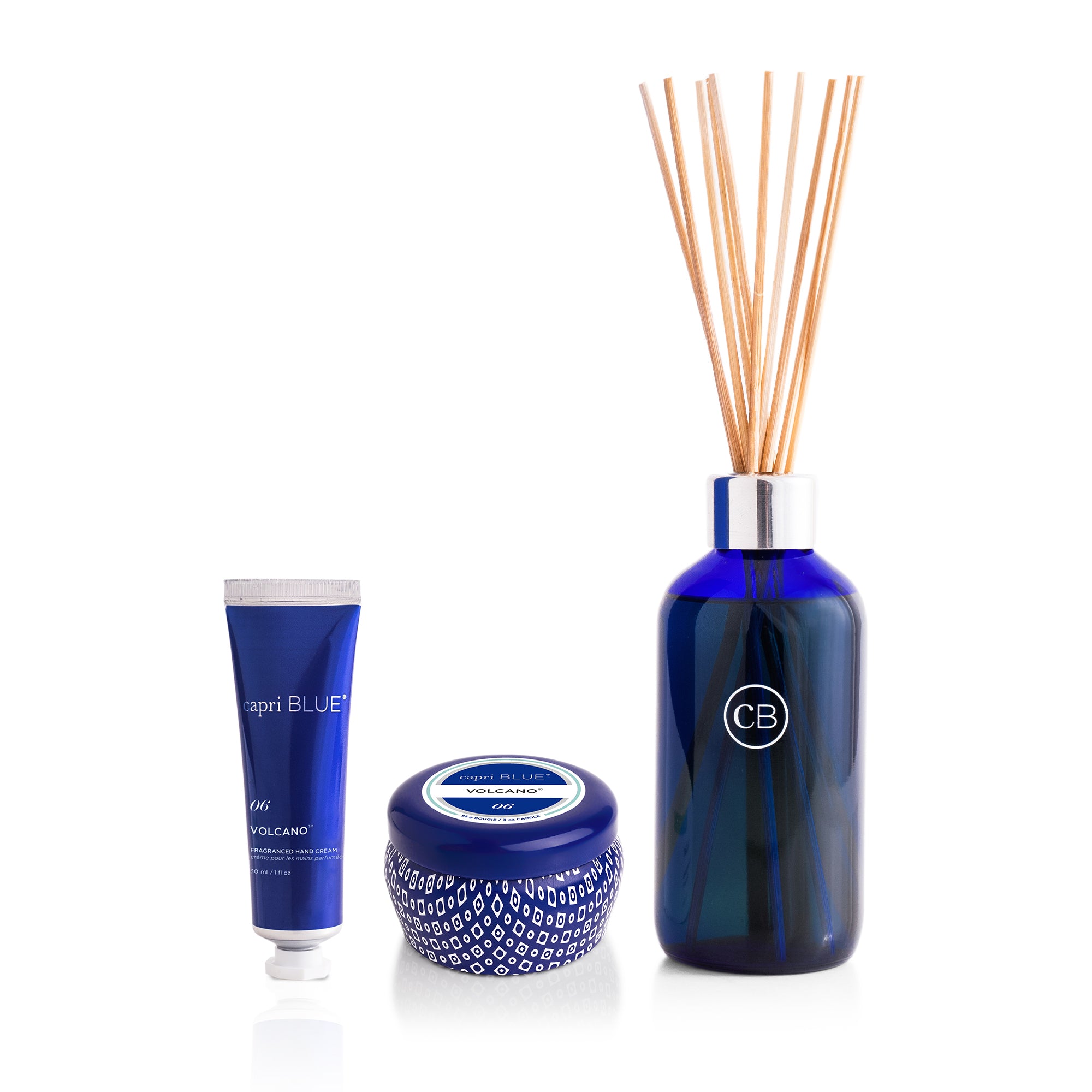 Volcano mini hand cream, blue mini tin candle and blue reed diffuser on a white background