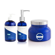 Three blue skincare products with silver caps on a white background