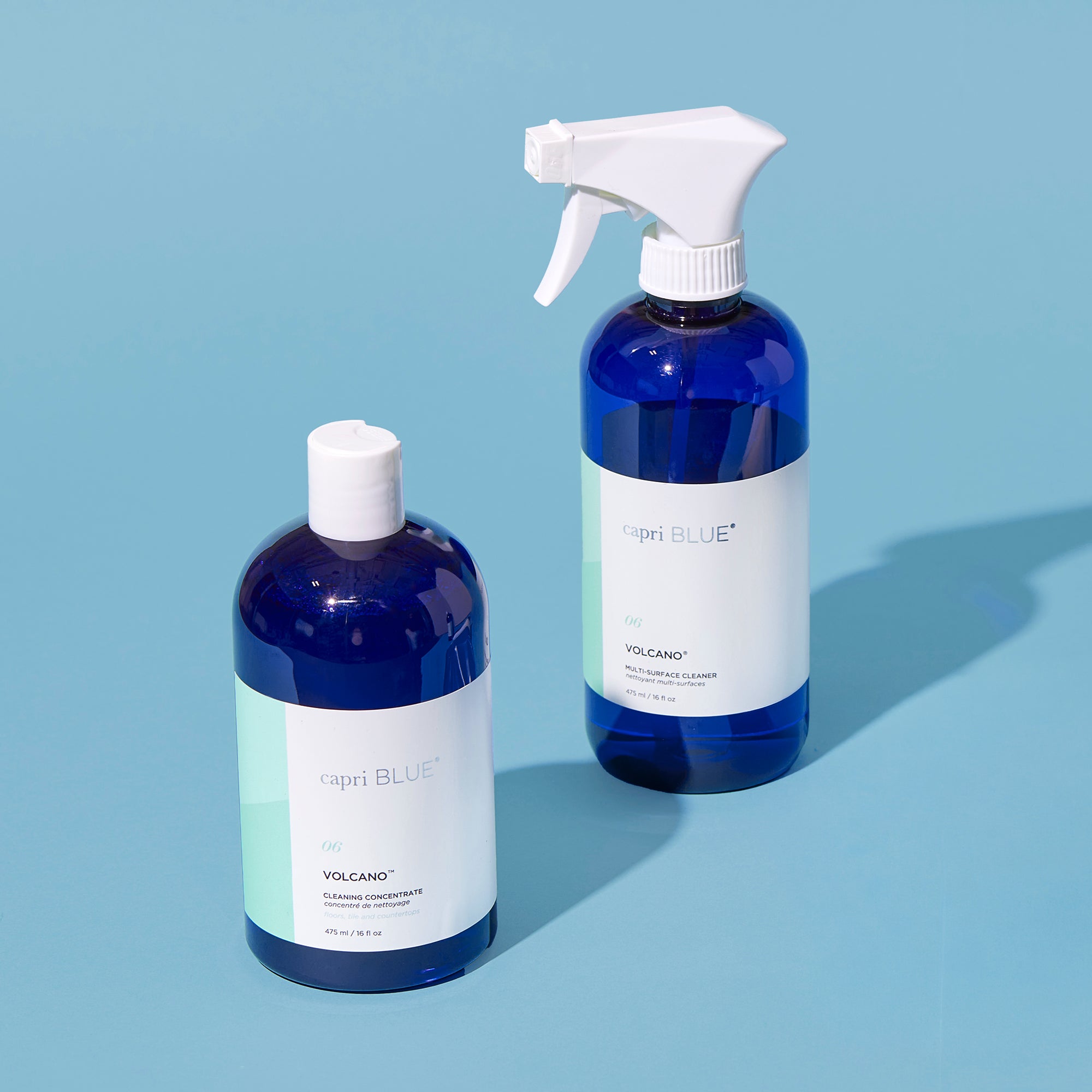 Two bottles of 'Blue' Volcano product on a light blue background