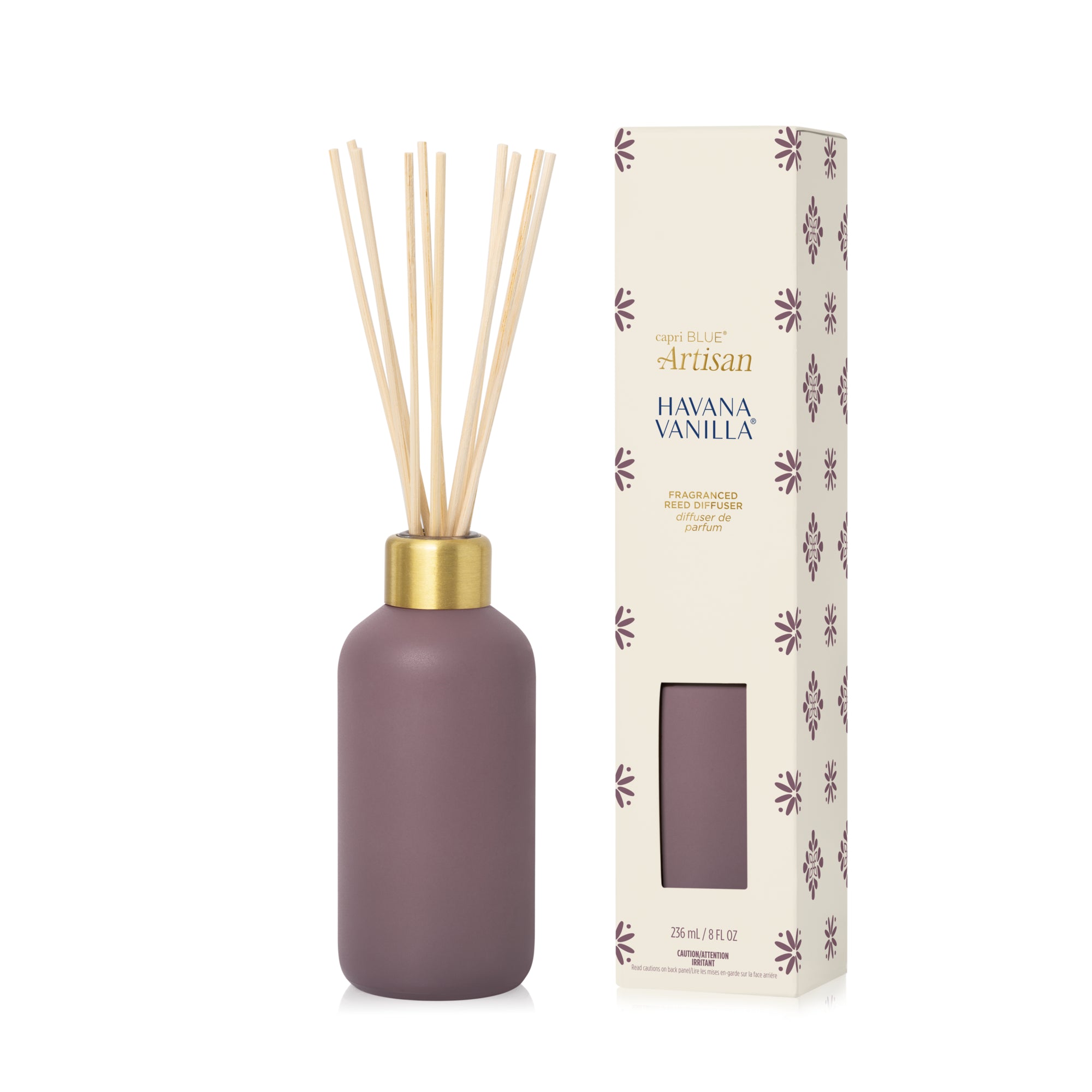 A matte mauve-pink diffuser bottle with gold cap and decorative packaging on a white background