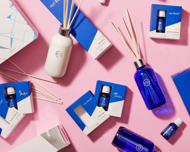 Diffuser bottles and packaging on a pink background