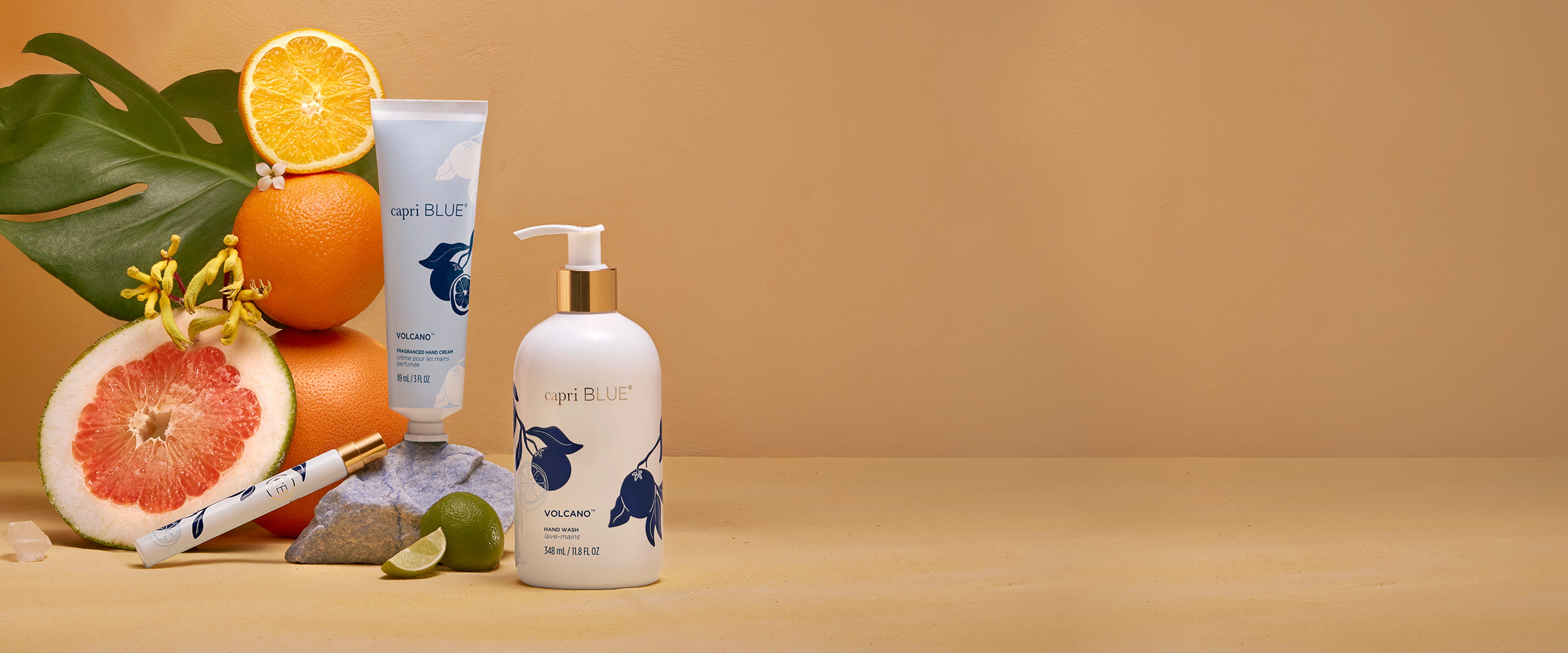 Two bottles of 'Blue Bell' skincare products on a beige background with fruits and leaves.