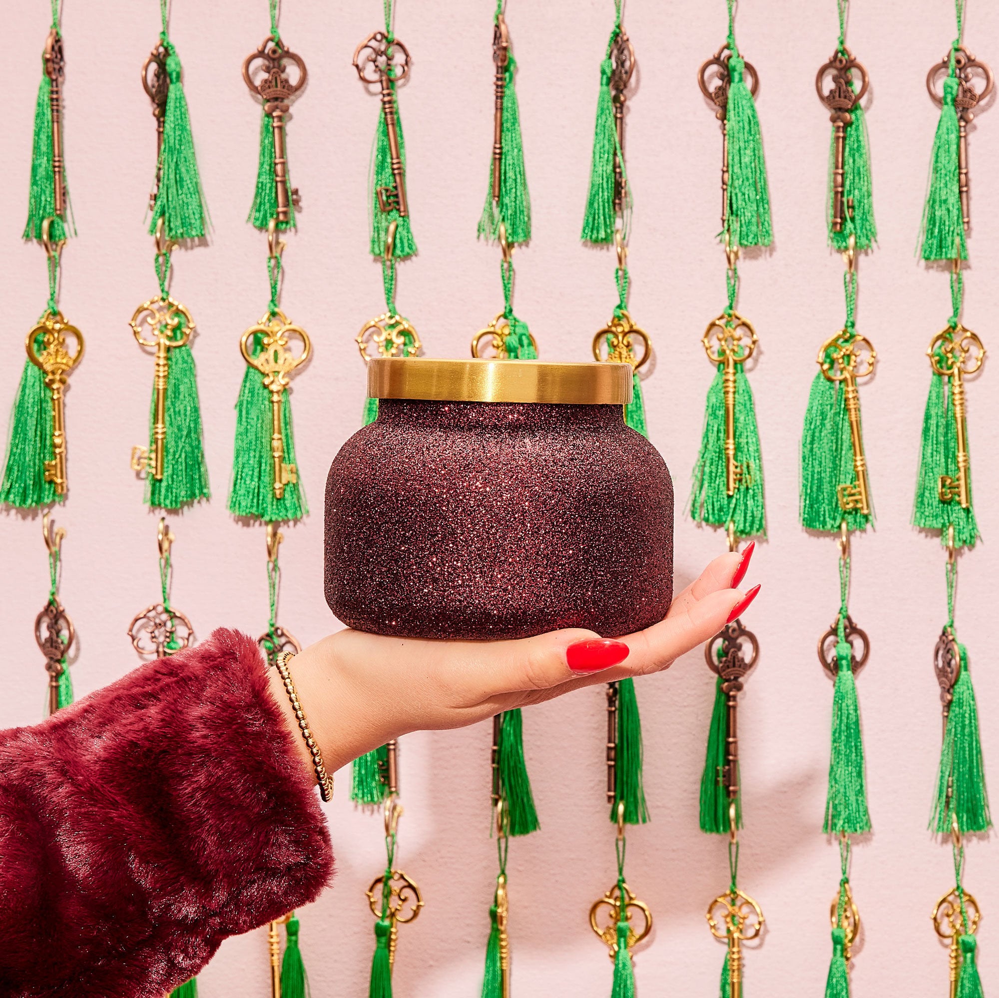 Tinsel & Spice Glam Signature Candle in hand